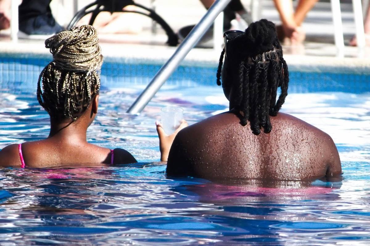 Woman performing basic water aerobics exercises in shallow pool with proper form